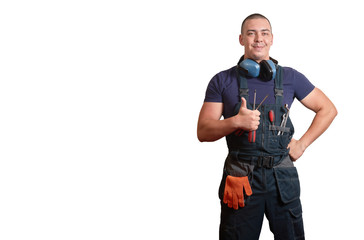 Strong male mechanic in blue overal standing on a white isolated background
