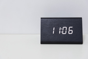 Black digital clock on a white background showing time 11:06
