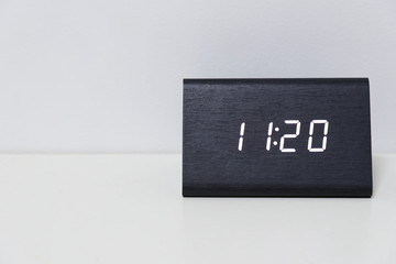 Black digital clock on a white background showing time 11:20