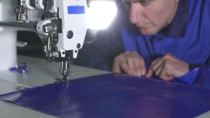 portrait of an Arab Muslim man at work on a sewing machine
