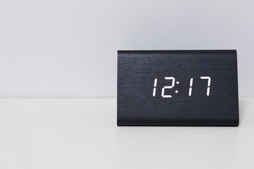 Black digital clock on a white background showing time 12:17