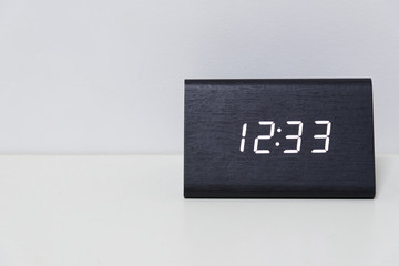 Black digital clock on a white background showing time 12:33