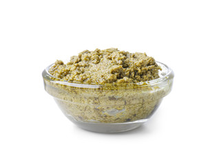 Tasty basil sauce in glass bowl on white background
