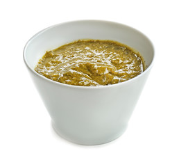 Tasty basil sauce in bowl on white background