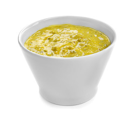 Tasty yellow sauce in bowl on white background