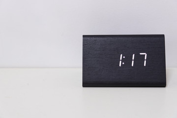Black digital clock on a white background showing time 1:17