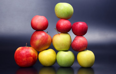 Wall of fresh different apples on dark background