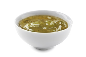 Tasty green sauce in bowl on white background