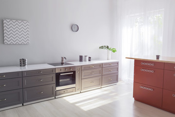 Interior of modern kitchen with stylish furniture