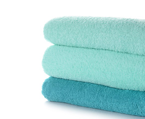 Stack of clean soft towels on white background