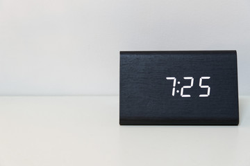 Black digital clock on a white background showing time 7:25