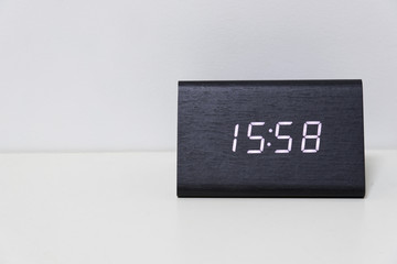 Black digital clock on a white background showing time 15:58