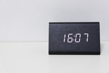 Black digital clock on a white background showing time 16:07