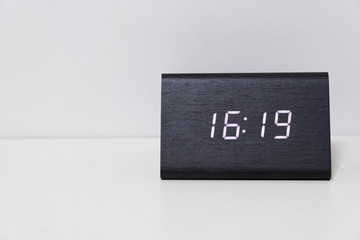 Black digital clock on a white background showing time 16:19