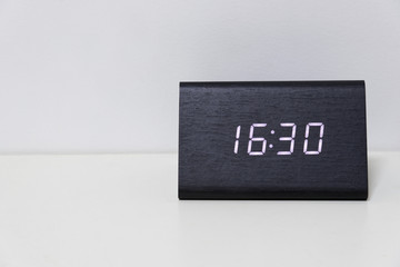 Black digital clock on a white background showing time 16:30