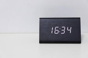 Black digital clock on a white background showing time 16:34