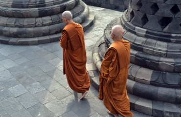 Monks walking around the stupa of Borobodur a 9th century Buddhist Temple in Magelang near...