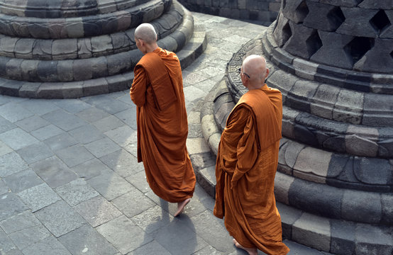 Monks walking around the stupa of Borobodur a 9th century Buddhist Temple in Magelang near Yogyakarta, Indonesia
