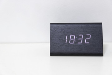Black digital clock on a white background showing time 18:32