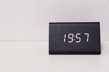 digital table clock showing 19:57 time
