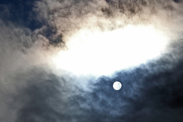 solar disk at noon through the clouds