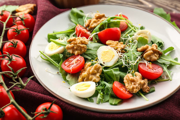 Delicious fresh salad with walnuts on plate