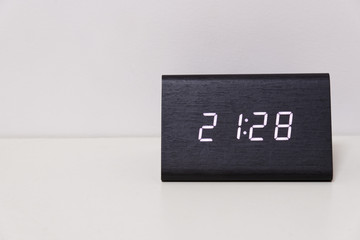 digital table clock showing 21:28 time