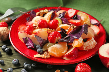 Delicious fresh salad with walnuts on plate