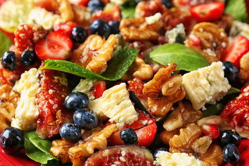 Delicious fresh salad with walnuts, closeup
