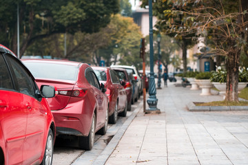 Fototapeta na wymiar Cars parked on the urban street side