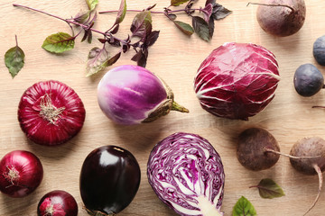 Various fresh vegetables with figs on wooden table