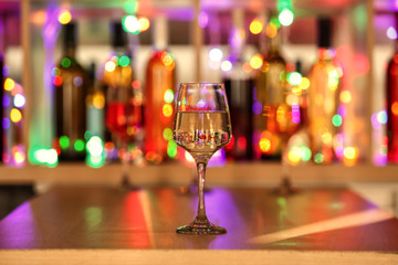 Glass of tasty wine on bar counter