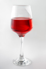 Glass of tasty wine on white background