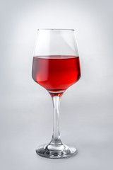 Glass of tasty wine on white background