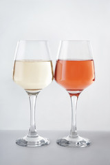 Glasses of tasty wine on white background