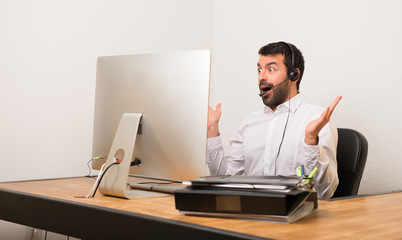 Telemarketer man in a office with surprise and shocked facial expression