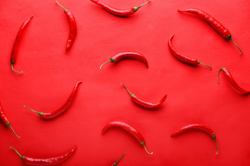 Fresh chili peppers on color background