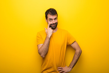 Man on isolated vibrant yellow color looking to the front