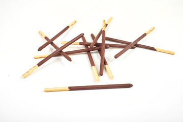 Fototapeta na wymiar Biscuit sticks in chocolate coating on white background.