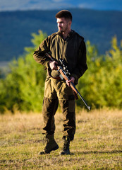 Hunter with rifle looking for animal. Hunting shooting trophy. Mental preparation for hunting...