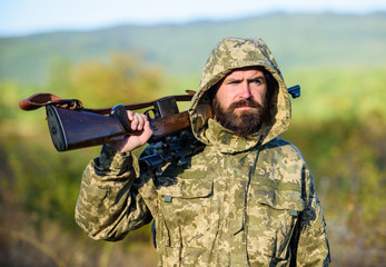 Guy hunting nature environment. Bearded hunter rifle nature background. Harvest animals typically...