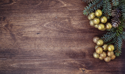 New Year's background. Spruce branches on a wooden table. Ornaments for the New Year tree. Christmas concept.