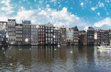 Typical dutch old houses over canal with snow, Amsterdam, Netherlands