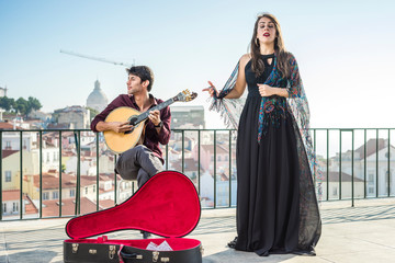 Beautiful fado singer performing with handsome portuguese guitarist player, Portugal