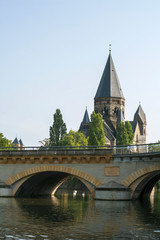 Beautiful ancient castle near the bridge and river in the summer day under the blue sky in Metz