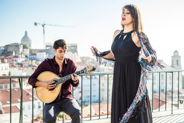 Beautiful fado singer performing with handsome portuguese guitarist player, Portugal