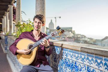 Fado musician playing on portuguese guitar in Lisbon, Portugal