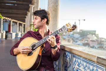 Fado musician playing on portuguese guitar in Lisbon, Portugal
