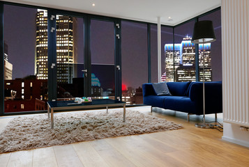 Modern living room with large windows and view on city panorama - obrazy, fototapety, plakaty