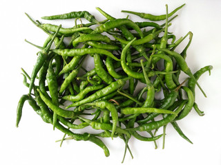 Top view of a pile of raw green sweet Chili (chilli), Chili pepper isolated on white background. No spicy taste. Ingredient for dishes in Taiwanese cuisine. Natural agricultural product and vegetable.
